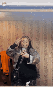 a woman is taking a picture of herself in a mirror with the name p.s. kagoya on the bottom