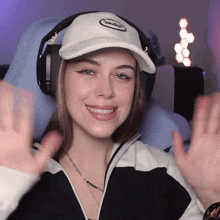 a woman wearing headphones and a white hat that says smash