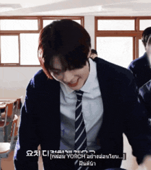 a man in a suit and tie is smiling in a room