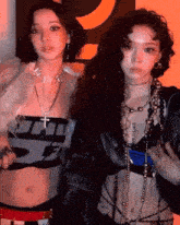 a couple of women standing next to each other with one wearing a necklace that says ' do it ' on it