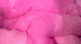 a close up of a person 's breasts in a pink latex suit .