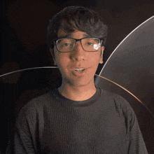 a man wearing glasses and a lucian shirt