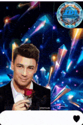 a man in a tuxedo is holding a red rose in front of a colorful background with a photolab logo