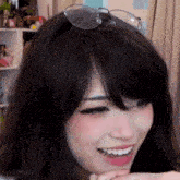 a woman wearing glasses and a wig is smiling and laughing .