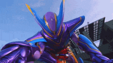 a purple and blue robot is standing in front of a building with a blue sky in the background
