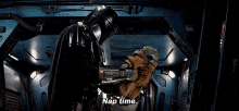 a man in a helmet is holding a baby and says nap time .
