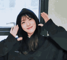 a woman wearing a black hoodie with the word webers on the front