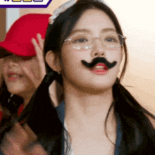 a girl wearing glasses and a fake mustache