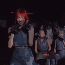 a woman with red hair is standing in front of a chair that says dean74