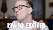 a man wearing glasses is saying `` i 'm so excited '' while making a funny face .