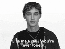 a black and white photo of a young man with the words give me a call if you 're ever lonely below him