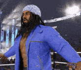 a man in a blue jacket is standing in a wrestling ring with a sign that says fnlw