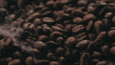 a pile of coffee beans with smoke coming out of the top