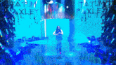 a woman stands on a stage in front of a wall that says tatum oakley