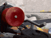 a red circle with a screw on it is on a machine