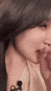 a close up of a woman wearing a microphone around her neck