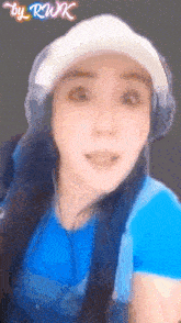 a woman wearing headphones and a hat with the name rwk written on the bottom