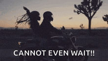 a man and a woman are riding a motorcycle on a desert road at sunset .