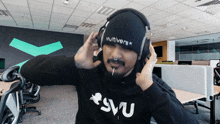 a man wearing headphones with the word multiverse on it