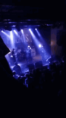 a blurred image of a concert with the word ghosts visible on the stage