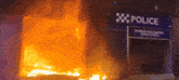 a police building is on fire with smoke coming out of the windows