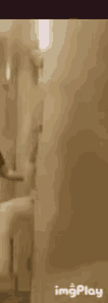 a woman in a white dress is standing next to a door .