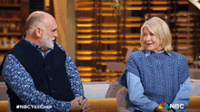 a man and a woman are sitting next to each other on a couch with nbc written on the bottom