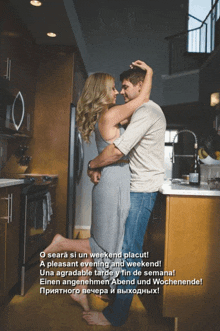 a man and a woman are hugging in a kitchen with the words o seara si un weekend placut