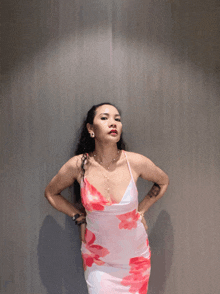 a woman in a pink and white dress with a tattoo on her arm