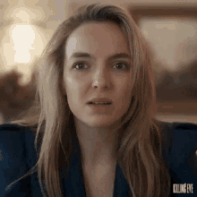 a close up of a woman 's face with a surprised expression .