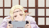 a girl with a flower in her hair is playing a game