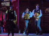a group of people are dancing on a stage