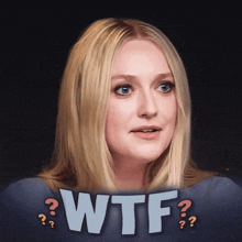 a woman with blonde hair stands in front of the word wtf