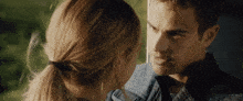 a man and a woman are looking at each other in a close up
