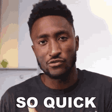 a man with a beard is wearing a black shirt with the words so quick on it
