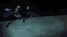 a person is standing in the dark with a blue light coming out of their feet .