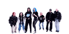 a group of women are standing in a row and one of them has a shirt that says acne studios