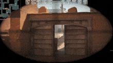 a sniper scope shows a doorway leading to a building with stairs