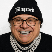 a man wearing glasses and a beanie that says blazzard on it
