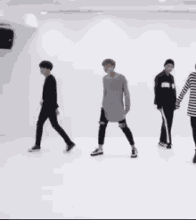 a group of young men are dancing together in a room .