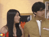 a man and a woman are standing next to each other and the man has a name tag that says river on it