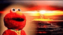 elmo from sesame street is standing in front of a giant explosion .