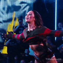 a woman dressed as freddy krueger is dancing in front of a crowd