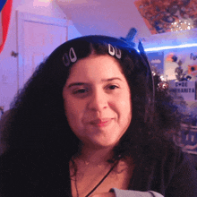 a woman wearing headphones is smiling in front of a sign that says c de margarita
