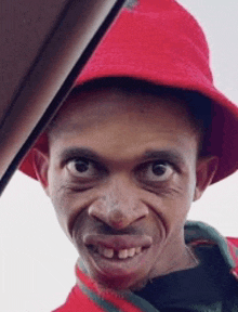 a man wearing a red hat and a red shirt looks at the camera