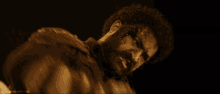 a close up of a man with blood on his face and the words nandamuriram on the bottom left