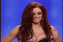 a woman in a very revealing top is on a television show
