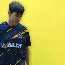 a man wearing a black shirt with the number 24 on the back