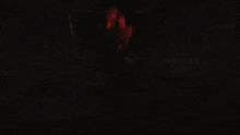 a purple light is coming out of a red light in the dark