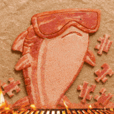 a piece of bacon that looks like a shark with goggles on